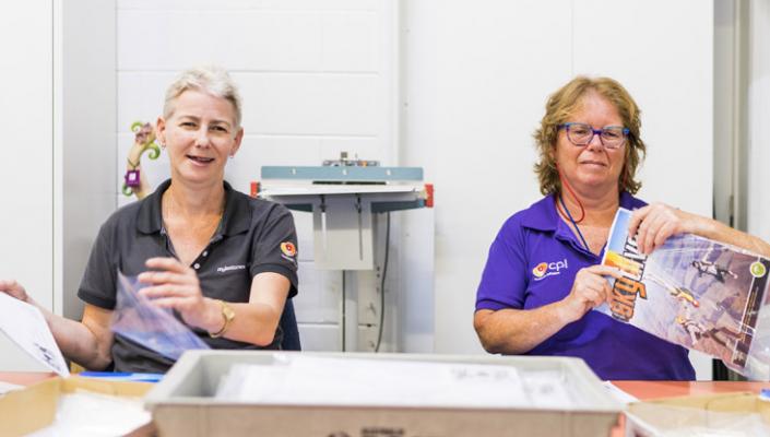 Two people at work smiling and happy