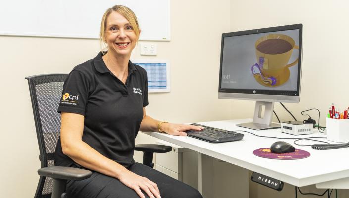 Mylestones team member sitting at a desk