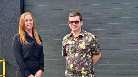 Robbie and Jess standing together in front of a Mylestones building